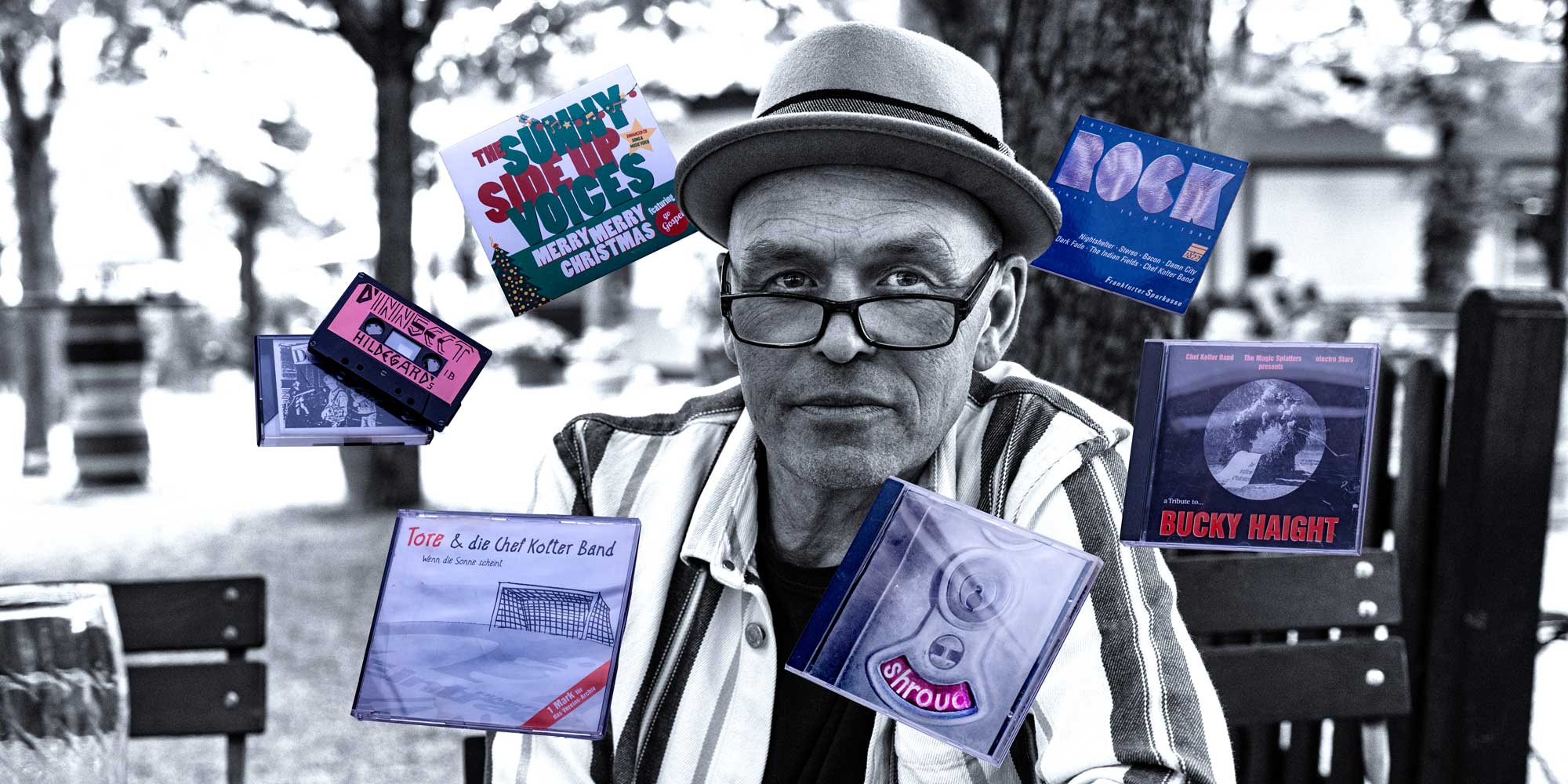 Young man with dark hair and beard, brown eyes, blue t-shirt