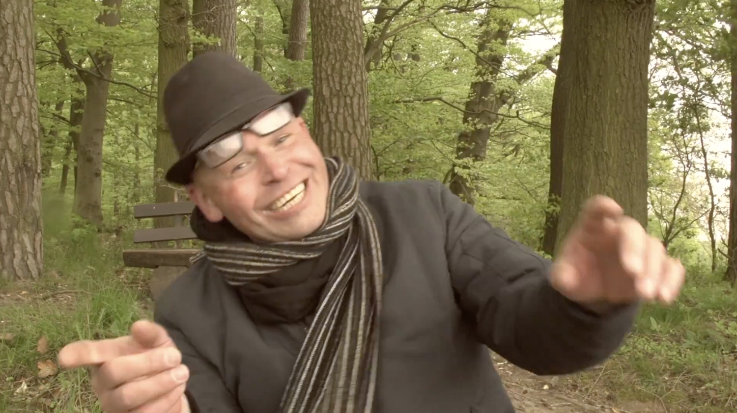 Young man with dark hair and beard, brown eyes, blue t-shirt